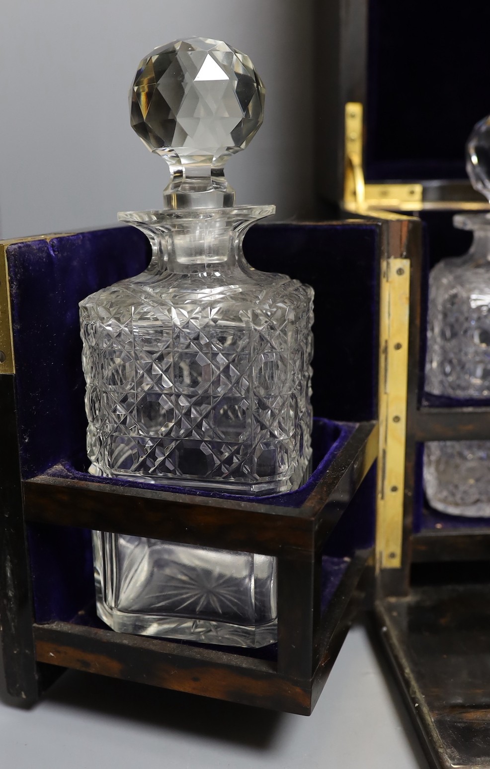 A Mappin & Webb coromandel decanter box with blue velvet lining. 32cm tall, four associated cut glass decanter and stoppers